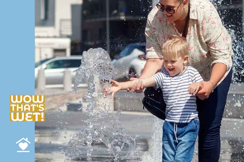 Child with parent putting hand in water